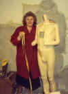 Annette Buckley seeing if 'David', the Grocer mannequin, measures up!